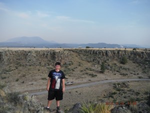 06-24 Anthony on the top the truck below and Escudilla Mountain in the background There is a forest fire creating a smoky Haze Decided to head up to Colorado a couple of days early.